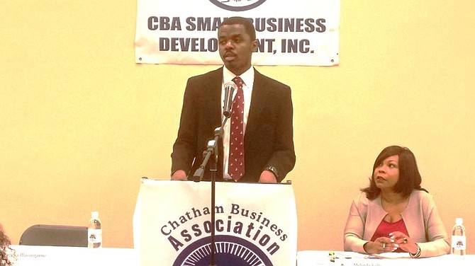 Alexander Buckles, Supplier Diversity Analyst for the McCormick Place in Chicago, speaks during the Chatham Business Association (CBA) monthly meeting on Tuesday, Oct. 13, 2015 as CBA Executive Director, Melinda Kelly listens in.