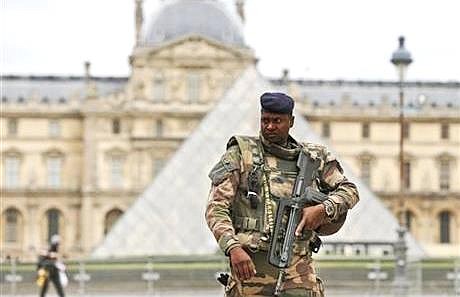 A soldier patrols in the courtyard of the Louvre Museum in Paris, Tuesday, Nov. 17, 2015. France made an unprecedented demand on Tuesday for its European Union allies to support its military action against the Islamic State group as it launched new airstrikes on the militants' Syrian stronghold.