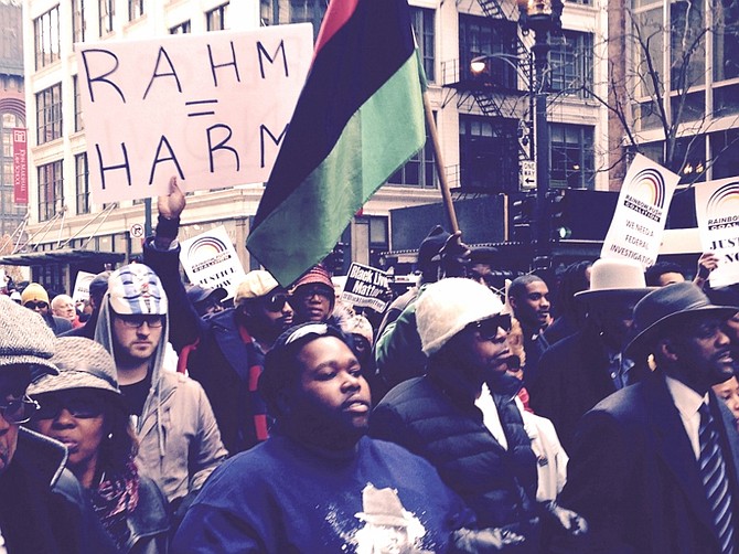 Hundreds march in downtown Chicago to protest the shooting of a black teen killed by a white Chicago police officer.