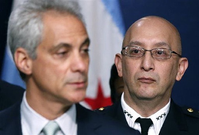 Chicago Police Superintendent John Escalante, right, listens to Chicago Mayor Rahm Emanuel during a news conference about new police procedures on Wednesday, Dec. 30, 2015, in Chicago. Emanuel says every Chicago police patrol car will be equipped with a Taser following a series of high-profile shootings by officers.