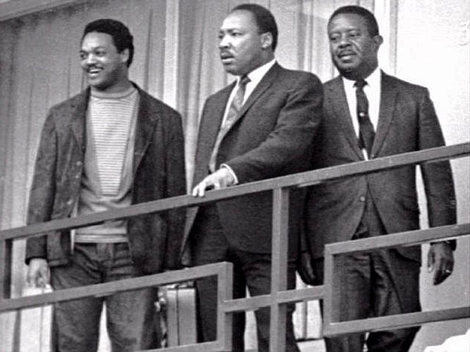 Dr. Martin Luther King, Jr., (center), Rev. Jesse Jackson (left) and Ralph Abernathy (right) return to the Lorraine Motel in Memphis to strategize for the second Sanitation Worker's march led by King in this April 3, 1968 file photo. King was shot dead on the balcony April 4, 1968.  AP