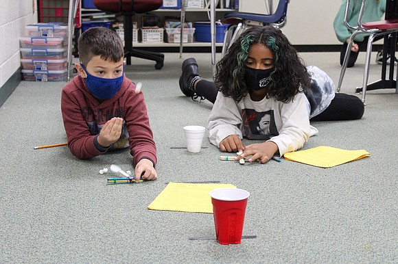 Meadow View Elementary School fourth graders in Nicole Szaler's class try to launch marshmallows into a cup with their homemade ...