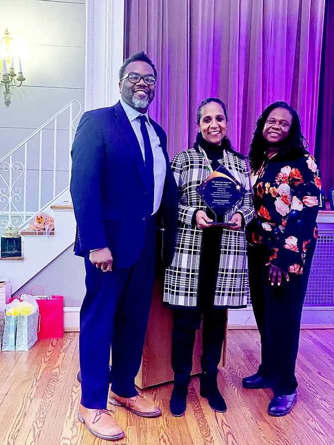 Cook County Commissioner Brandon Johnson (left) presents an award to Cook County Bureau of Economic Development Director Susan Campbell (center) as Oak Park Regional Housing Center Executive Director Athena Williams (right) watches during the March 24 “Heroines of Housing” luncheon held at The Nineteenth Century Club in Oak Park.