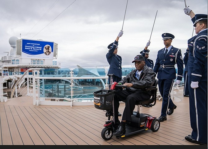 Retired Lt. Colonel James H. Harvey III is greeted with an Honor Cordon by members of the McChord Field Honor Guard on Discovery Princess during a special 100th Birthday celebration for the Tuskegee airman. PRNewsfoto/Princess Cruises