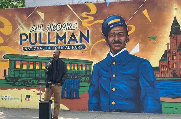 Joe Nelson speaks about the inspiration for the mural he created highlighting the contributions of the Pullman porters. PHOTO BY TIA CAROL JONES