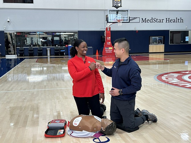 MedStar Health Emergency Physician Alex Koo, MD, and Washington Mystics Head of Rehabilitation Kala Flagg, DPT, ATC, CSCS, demonstrate CPR and AED administration for the new video campaign. PRNewsfoto/MedStar Health.