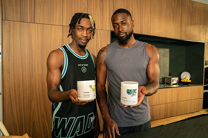 Dwyane Wade and Zaire Wade with Thorne Daily Greens Plus and Amino Complex. PRNewsfoto/Thorne HealthTech, Inc.