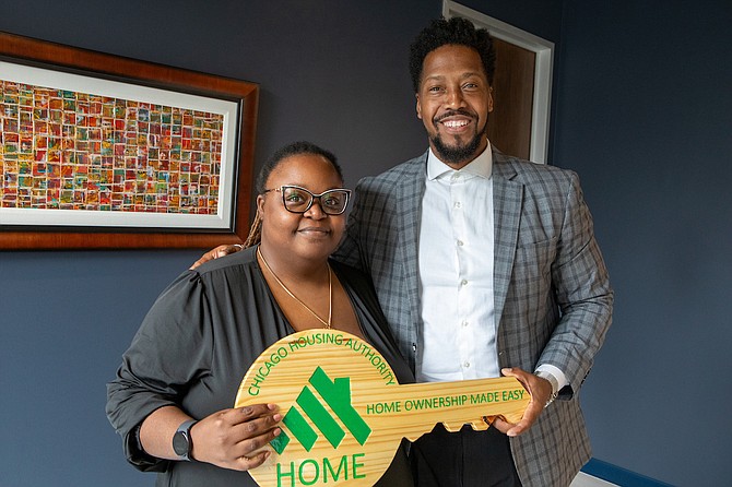 Samantha Stokes, the first Chicago Housing Authority resident to close on a home in the CHA’s new Down Payment Assistance (DPA) program, stands with DPA Program Manager Jimmy Stewart at her closing in early October.