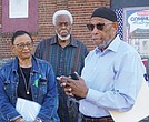 From left, Viola Baskerville, Leonard Edloe and Gary Flowers look on as Sa’ad El-Amin, center, speaks during a press conference Tuesday on a lawsuit seeking to prevent Virginia Union University’s demolition of the Richmond Community Hospital building on the hospital’s front lawn.