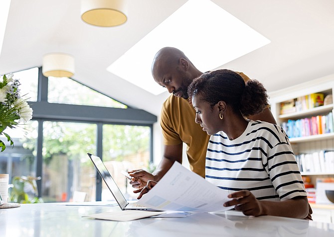 Couple paying bills-going over finances.  (Photo source: Royalty Free)