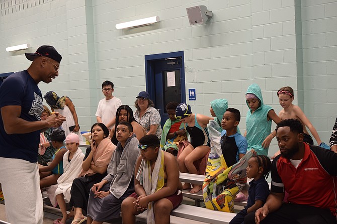 Olympic swimmer Cullen Jones working with young people during a swimming event. Photo credit: USA Swimming.