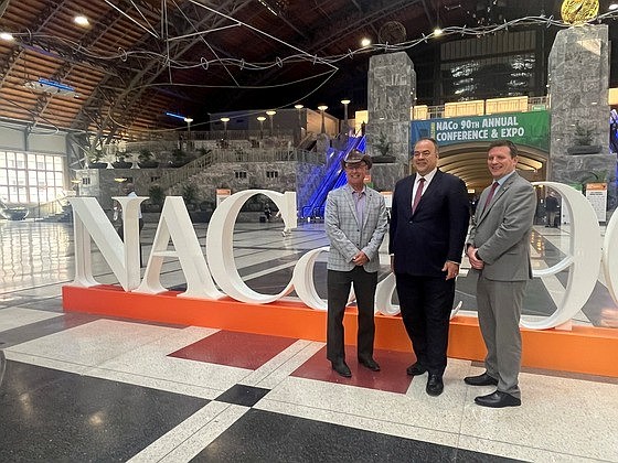 Cook County Assessor Fritz Kaegi (center) stands with Maricopa County Assessor Eddie Cook (left) and Philadelphia Chief Assessment Officer James “AJ” Aros (right) at the annual conference of the National Association of Counties, July 11, 2025.