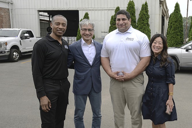 7th Ward Alderman Greg  Mitchell, PsiQuantum CEO Victor Peng, 10th Ward Alderman Peter Chico  and PsiQuantum’s Chief Financial Officer Susan Kim, pose for a photo before a roundtable discussion with local community leaders in South Chicago.  After the session they toured Affordable Welding, which supplied roughly 400 tons of structural steel for PsiQuantum's building at the IQMP.  Photo Courtesy of PsiQuantum