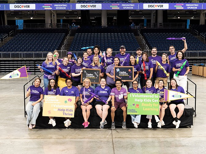 Cradle to Crayons staff and organizers gathered for a photo before packing backpack for students at their annual Backpack Event.  Photo by Tom Garvey.