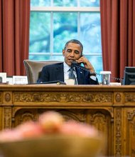 President Barack Obama talks with President Vladimir Putin of Russia during a phone call in the Oval Office, July 12, 2013.