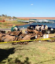 Oklahoma deputies pull bodies from a lake in Custer County, Oklahoma on September 18, 2013. The bodies may be from disappearances dating back to the 1960s and 1970s.
