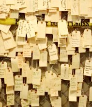 As part of the interactive portion of the Kin Killin Kin exhibit, visitors can write the name of someone close to them who was lost to gun violence and tie it on the chain link-fence memorial part of the exhibit. Ward said tags on the memorial fence grew from three that were tied there as an example of how to use it when the exhibit first opened, to the thousands that have been tied as real memorials there since.