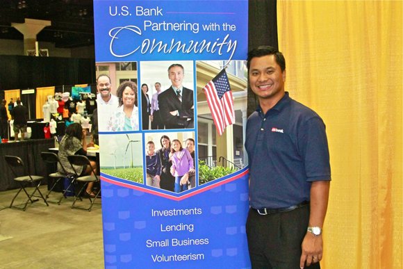 A US Bank representative takes a moment from manning the booth.