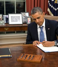 President Barack Obama signs H.R. 3210, Pay Our Military Act, which provides continuing appropriations for pay and allowances for members of the Armed Forces during any period for which interim or full-year appropriations for FY 2014 are not in effect, in the Oval Office, Monday night, Sept. 30, 2013.