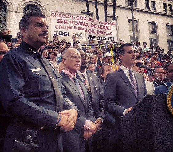 With hundreds of labor and immigrant-rights activists looking on, Gov. Jerry Brown sat at a desk outside Los Angeles City ... With hundreds of labor and immigrant-rights activists looking on, Gov. Jerry Brown sat at a desk outside Los Angeles City ...