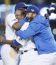 Los Angeles Dodgers Juan Uribe, center, and Matt Kemp, right, celebrate their 4-3 victory over the Atlanta Braves Tuesday night at Dodger Stadium to win their National League Division Series.