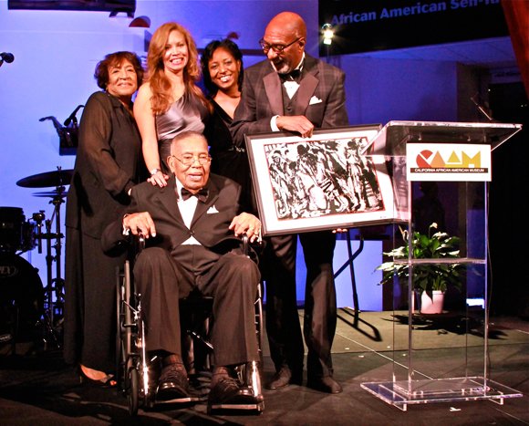 L.A. business owner and philanthropist Leon T. Garr (seated), is surrounded by family and friends after receiving CAAM’s Lifetime Achievement Award.