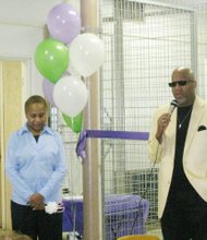 Rev. Stephen J. Thurston, Sr., pastor of New Covenant Missionary Baptist Church, 740, E. 77th St., offers a word prayer and blessing during the ribbon cutting of the new Seed of Hope Food Pantry located at the church. The ribbon cutting ceremony was held Sept. 21 Carlene Scales Lilly, director of the Seed of Hope Food Pantry is also pictured. Photo courtesy of New Covenant Missionary Baptist Church