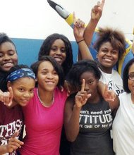 Hyde Park Academy girl’s basketball players and their coach pose with the Chicago Sky mascot, Fly Guy. The Chicago Sky, a professional women's basketball team based in Rosemont, Ill., donated much needed basketball apparel to the Hyde Park Academy Lady Thunderbird girls basketball team last month. 