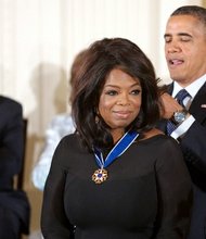 President Barack Obama awards the 2013 Presidential Medal of Freedom to Oprah Winfrey during a ceremony in the East Room of the White House, Nov. 20, 2013.
