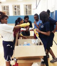 Hyde Park Academy girl’s basketball players are surprised by much needed basketball apparel donated to them last month by the The Chicago Sky, a professional women's basketball team based in Rosemont, Ill.