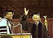 Mandela waves at a auditorium that was filled to capacity
