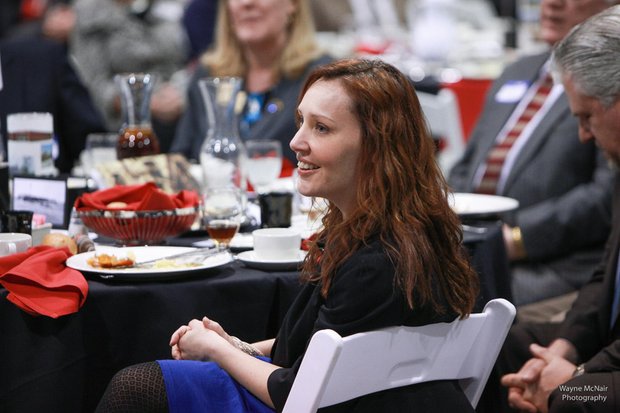 Romeoville Mayor John Noak's Wife, Jennifer, looks on as the mayor gave his State of the Village Address March 6 at Lewis University.