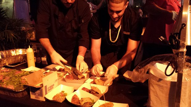 Staff prepares plates of food at the event.
