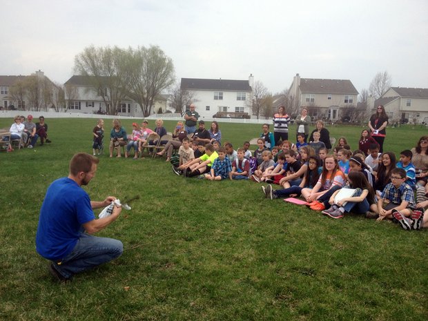 Jim Tieber, a certified arborist for Joliet, shows students how to plant a tree.