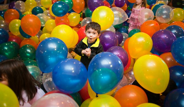 Alexander Rios, 2, of Joliet, plays in the balloon pit Saturday during the 10th annual Hippity-Hop Easter Egg Hunt at The Timbers of Shorewood.