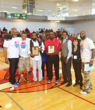 CUHC organizers: Eric Harrison, Rashard Lewis, one of the founders of the Chicago United Hoops Classic; Ron Eskridge,  Chicago United Hoops Classic Lifetime Achievement Award Recipient; William "Wolf" Nelson, Farragut HS Basketball Head Coach; Rob Smith, Chicago United Hoops Classic Lifetime Achievement Award Recipient; Jeffery Hammon, Managing Partner of Chicago United Ventures, LLC; Deanna Nord, Leadership Team Member,  Chicago United Ventures, LLC; and Jeff Maxey pose during the halftime Chicago United Hoops Classic Lifetime Achievement Award  ceremony.  