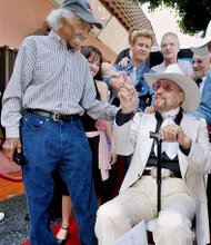 In this Friday, Sept. 24, 2004 photo, Herb Jeffries, a singing cowboy hero of the silver screen, right, is congratulated by jazz great Gerald Wilson following dedication ceremonies for Jeffries' star on the Walk of Fame in the Hollywood section of Los Angeles, on his 93rd birthday. Herb Jeffries, the first African-American singing cowboy to appear in movies in the 1930s, died of heart failure Sunday, May 25, 2014, at a Los Angeles hospital. He was 100.