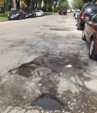 This pothole on Fulton Street between Francisco and Sacramento streets  is one of many that stretches along that block. To report potholes and request repair, Chicago residents are urged to call the City of Chicago's 311 or go to the City's website at cityofchicago.org.