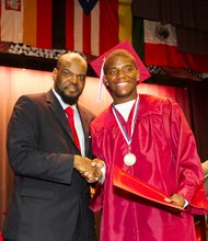 Ombudsman Chicago principal, Dr. Chaun Johnson, congratulates Nafis Maddox on graduating from Ombudsman Chicago.
