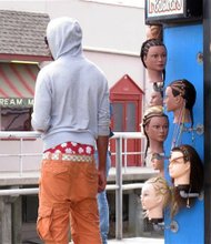 In a June 6, 2013 photo, a young man wears saggy pants on the Wildwood, N.J. boardwalk. Wildwood recently passed a law regulating how people dress on its boardwalk, including a prohibition on pants that sag more than 3 inches below the hips, exposing either skin or underwear. Mayor Ernest Troiano said Wildwood has been inundated with complaints from tourists upon whose money the popular beach town depends for its survival.