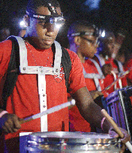 Drummers from the Ephesus Richmond Seventh-Day Adventist Church play upbeat music at a National Night Out event at Oak Grove Playground on South Side.