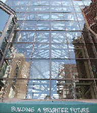 This optimistic slogan just seems like a bad joke. It’s attached to the front of this long-vacant glass palace in Downtown.
The “Building A Brighter Future” slogan sits above the entry to the one-time food court and restaurant space of the long-gone 6th Street Marketplace, a failed Downtown shopping mall, most of which was torn down.
This section, which survived, has been closed for at least seven years, with no indication city officials are actively marketing the space. For several years, private developers offered proposals to transform the building into apartments, but the city showed little interest and nothing came of the ideas.
So, for now, the brighter future remains on hold.