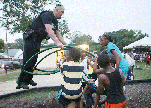 Neighbors and police officers gather for National Night Out.