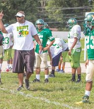 Coach Bryan Jennings orchestrates practice as the Huguenot High Falcons prepare for the first game.