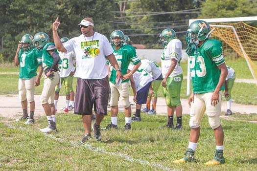 Coach Bryan Jennings orchestrates practice as the Huguenot High Falcons prepare for the first game.