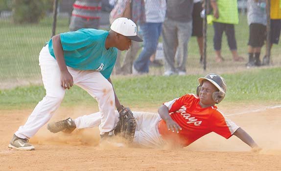 Darious Stanford covers for the Henrico Hitters as Kennedy Jones of the Hampton Grays slides safely into third base in a losing effort in the championship game of the Black World Series. The Hitters prevailed 14-4 to claim the title for 12 and under teams. Location: Parker Field Annex near The Diamond.