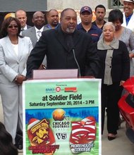 Larry Huggins, co-founder of the Chicago Football Classic, speaks on Monday during a press conference (with supporters in the background) about the upcoming traditional game to be played between Central State University, hailing from  Wilberforce, Ohio and Morehouse College of Atlanta, Ga., on Saturday, September 20 at Soldier Field football stadium.  Kick-off time is 3:00 pm.