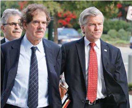 Former Virginia Gov. Bob McDonnell, right, arrives at federal court Tuesday with his attorney Henry Asbill.