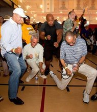 Chicago Mayor Rahm Emanuel celebrates with other attendees at one of several  watch parties he arranged as a way for the community to come together and cheer for the Jackie Robinson West All Stars who won the Little Baseball title as the 2104 U.S. Champions.