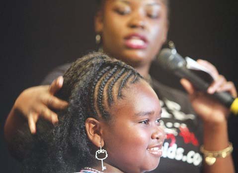 Ten-year-old Dejanyse Holland models a natural hairstyle by Simone Monae Johnson.